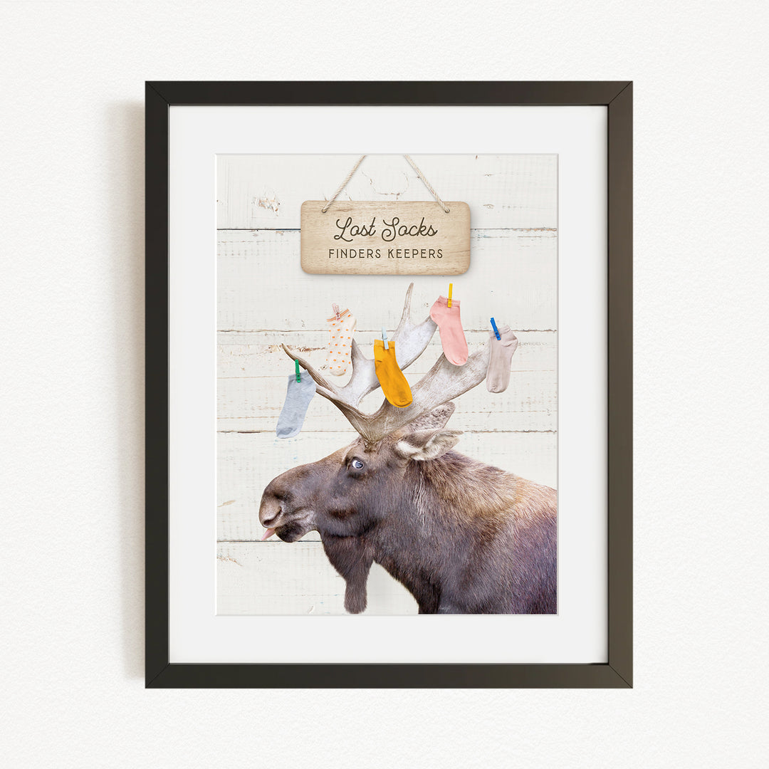 A framed image of a moose with a sign above it that says "Red Stock Finders Keepers".