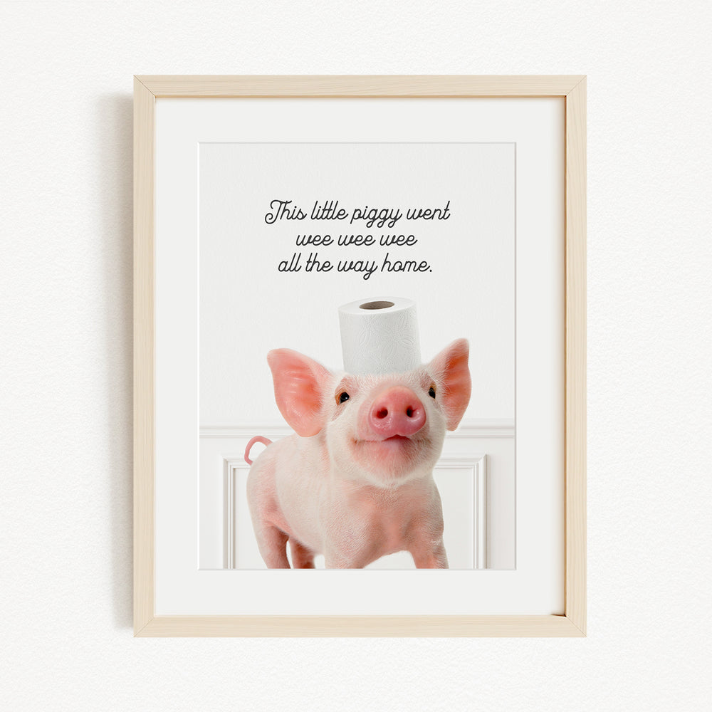A framed image of a pig with a roll of toilet paper on its head, accompanied by the text "This little piggy went weee weee all the way home."