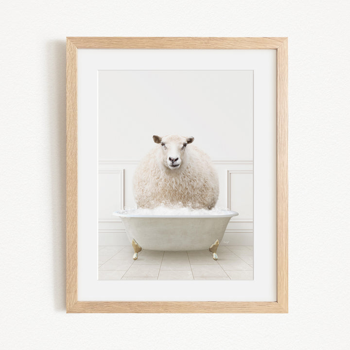 A fluffy white sheep sits in a white bathtub filled with bubbles, creating a whimsical and playful scene.