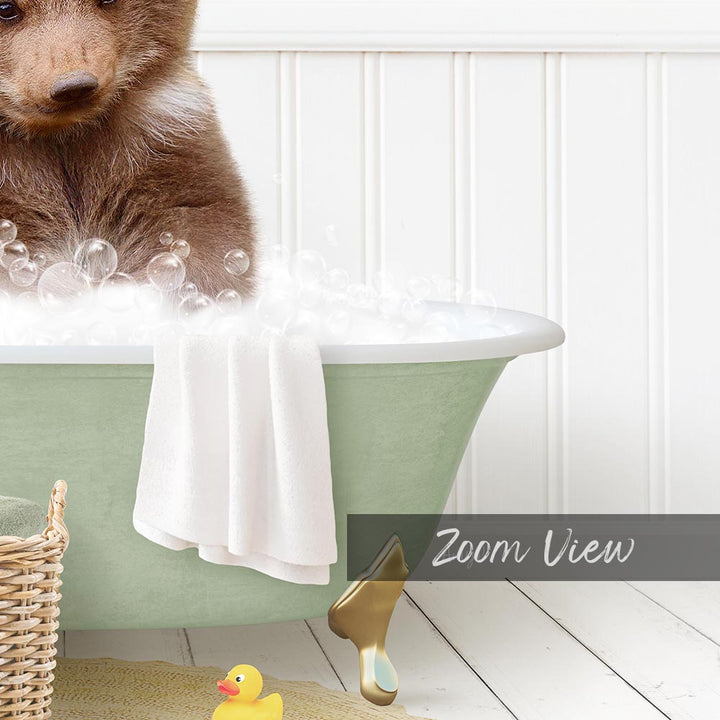 A brown bear is sitting in a green bathtub filled with bubbles, surrounded by a yellow rubber duck and a white towel.