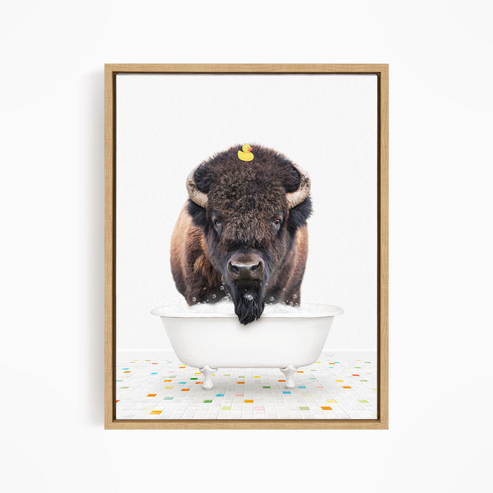 A buffalo with a yellow rubber duck sitting in a white bathtub.
