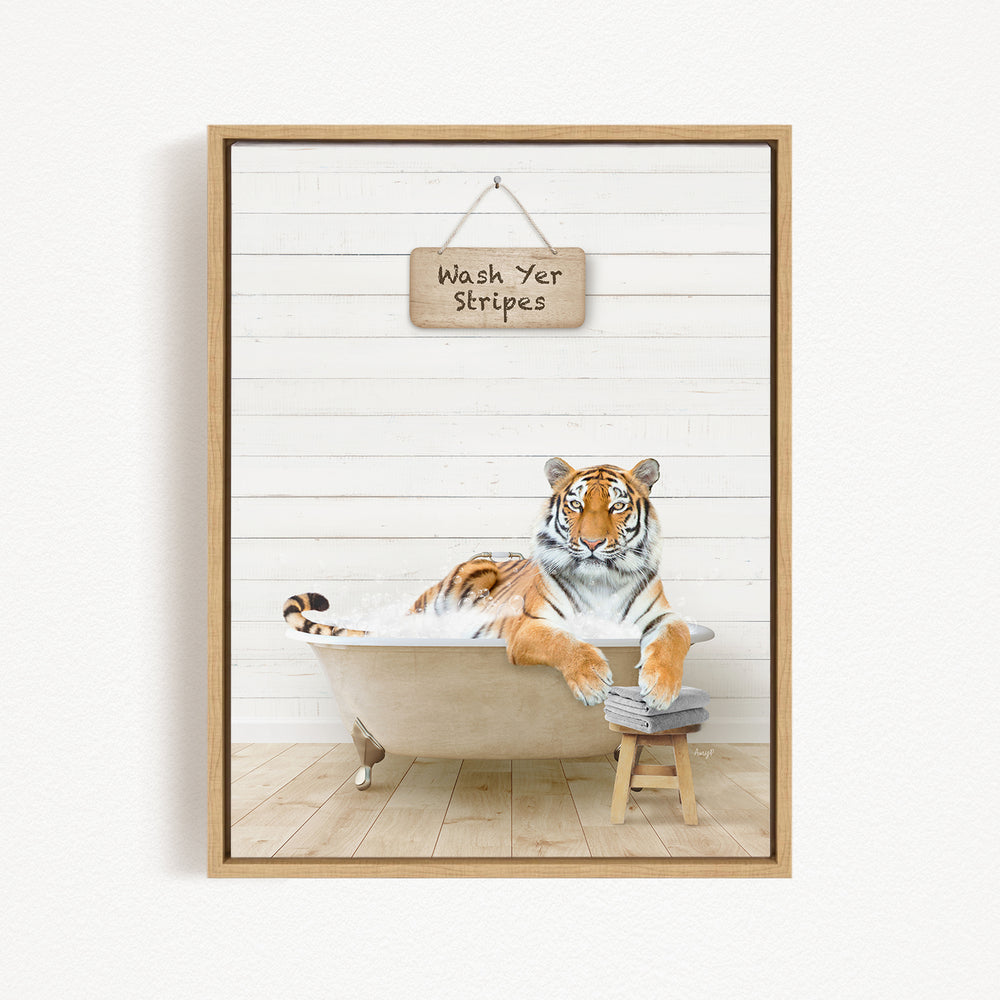 A tiger is sitting in a bathtub, with a sign above it that says "Wash Yer Stripes".