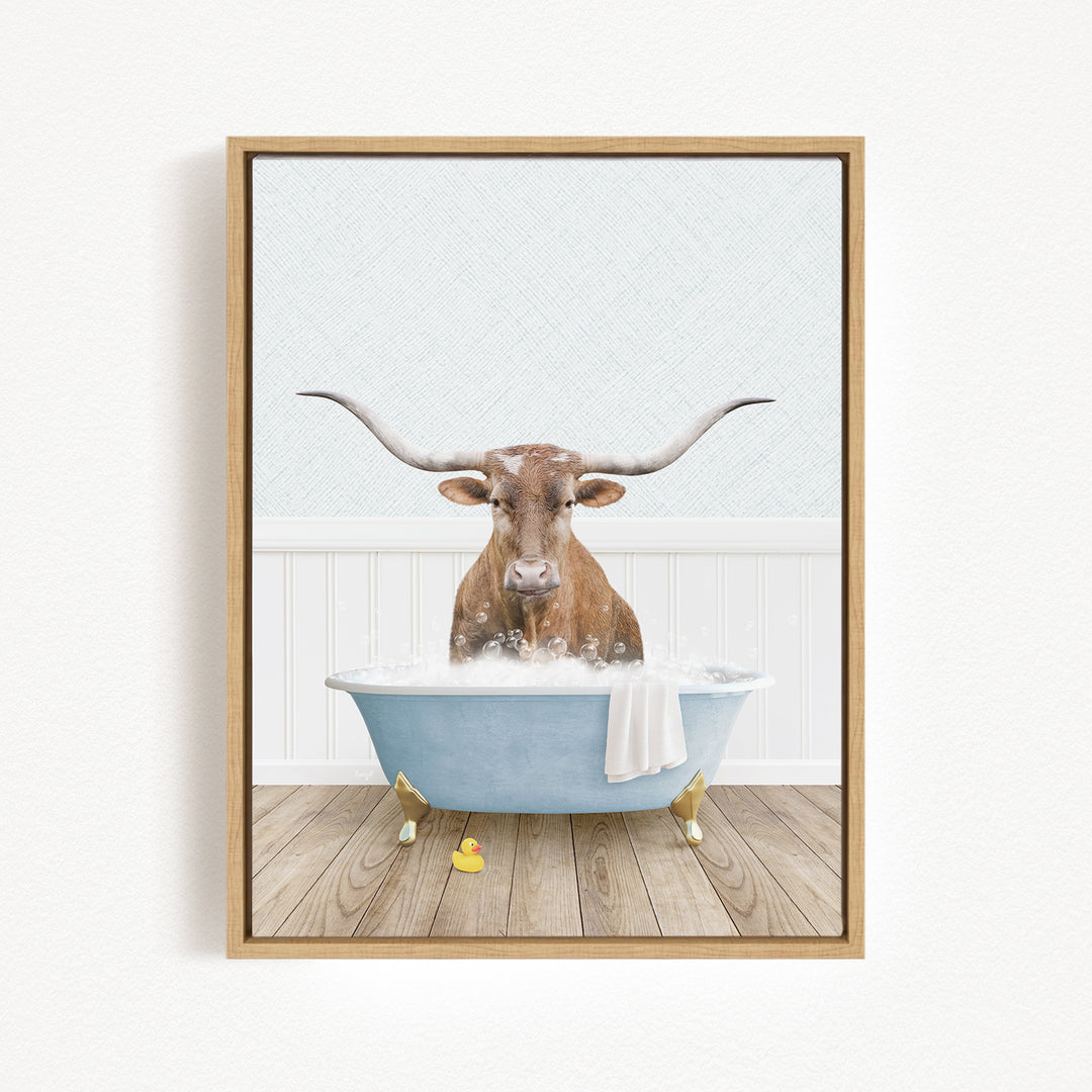 A brown cow with large horns is sitting in a blue bathtub filled with water, surrounded by rubber ducks.
