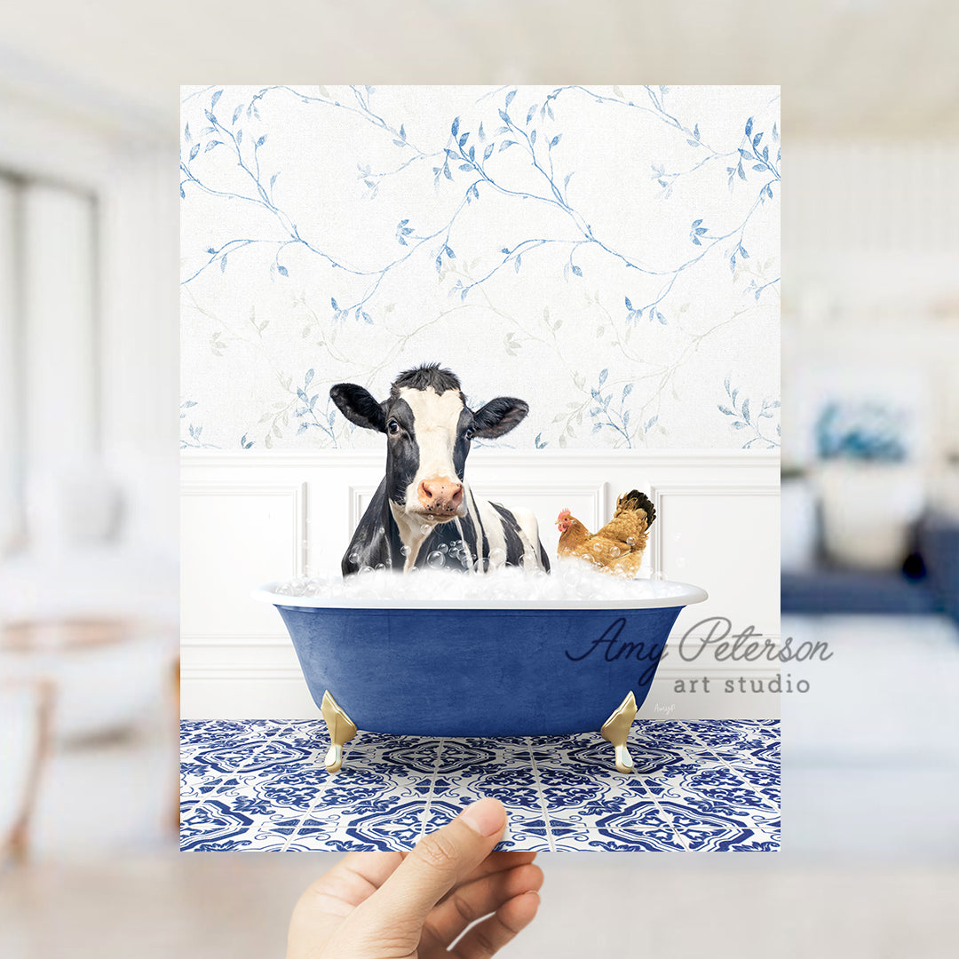 a hand holding up a card with a picture of a cow in a bathtub