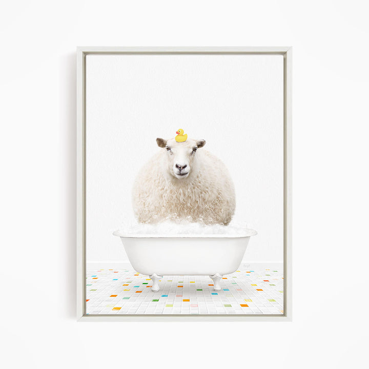 A fluffy white sheep sits in a white bathtub filled with bubbles, with a yellow rubber duck perched on its head.