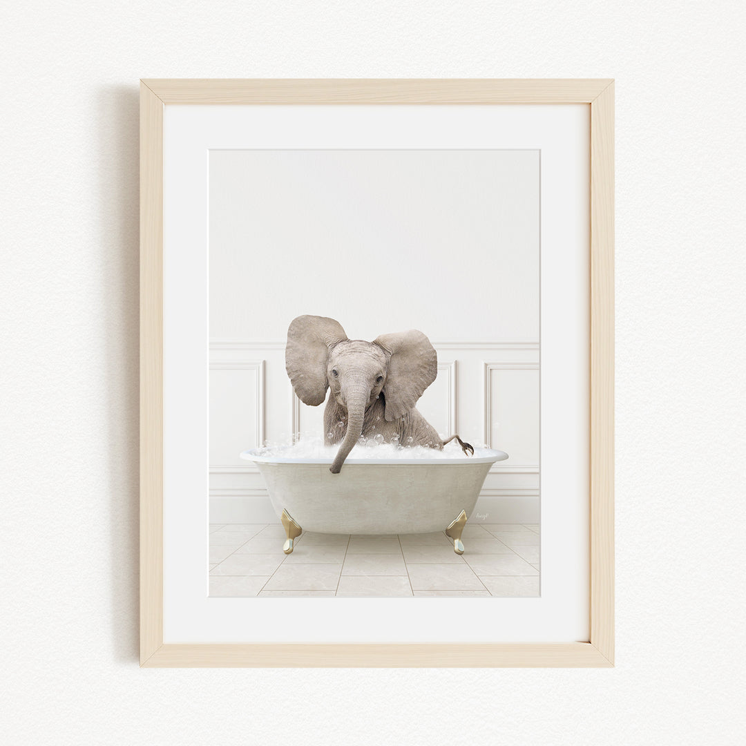 A baby elephant sitting in a white bathtub filled with water, with its trunk submerged in the water.