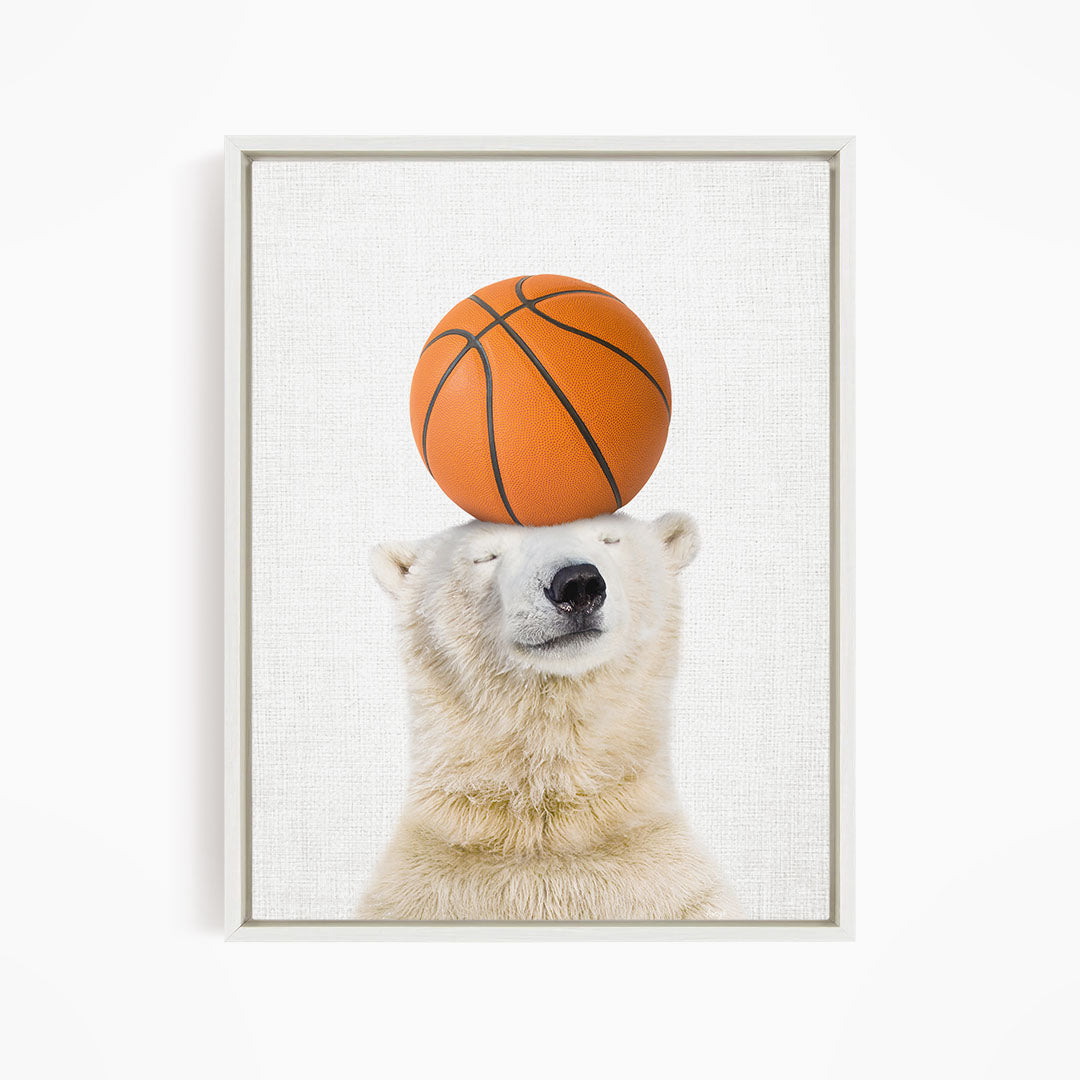 A polar bear balancing a basketball on its head.