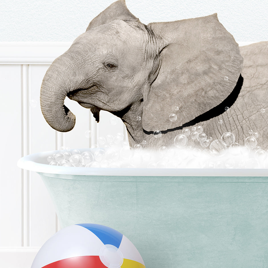 a baby elephant taking a bath in a bathtub