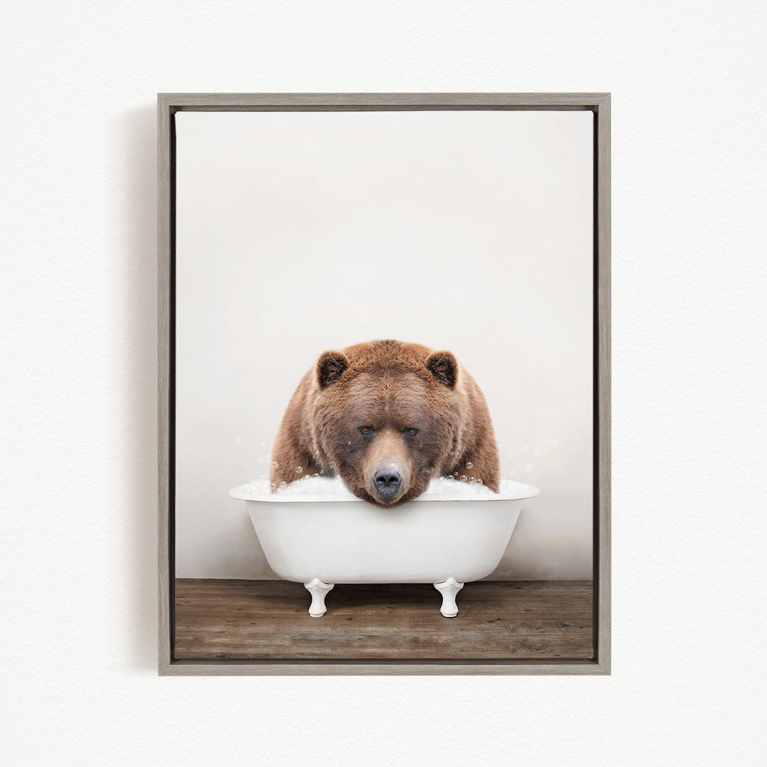 A brown bear sitting in a white bathtub filled with water, appearing to be enjoying a relaxing bath.