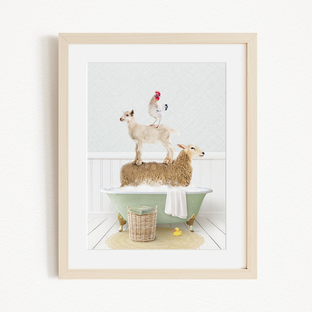 A framed image depicting a goat standing on a sheep's back while a rooster stands on top of a lamb in a bathtub.