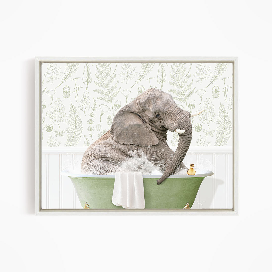 A gray elephant is sitting in a green bathtub filled with water, with a yellow rubber duck floating nearby.