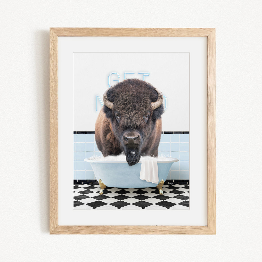 A buffalo standing in a bathtub filled with water, with a sign that says "GET IN THE WASH".