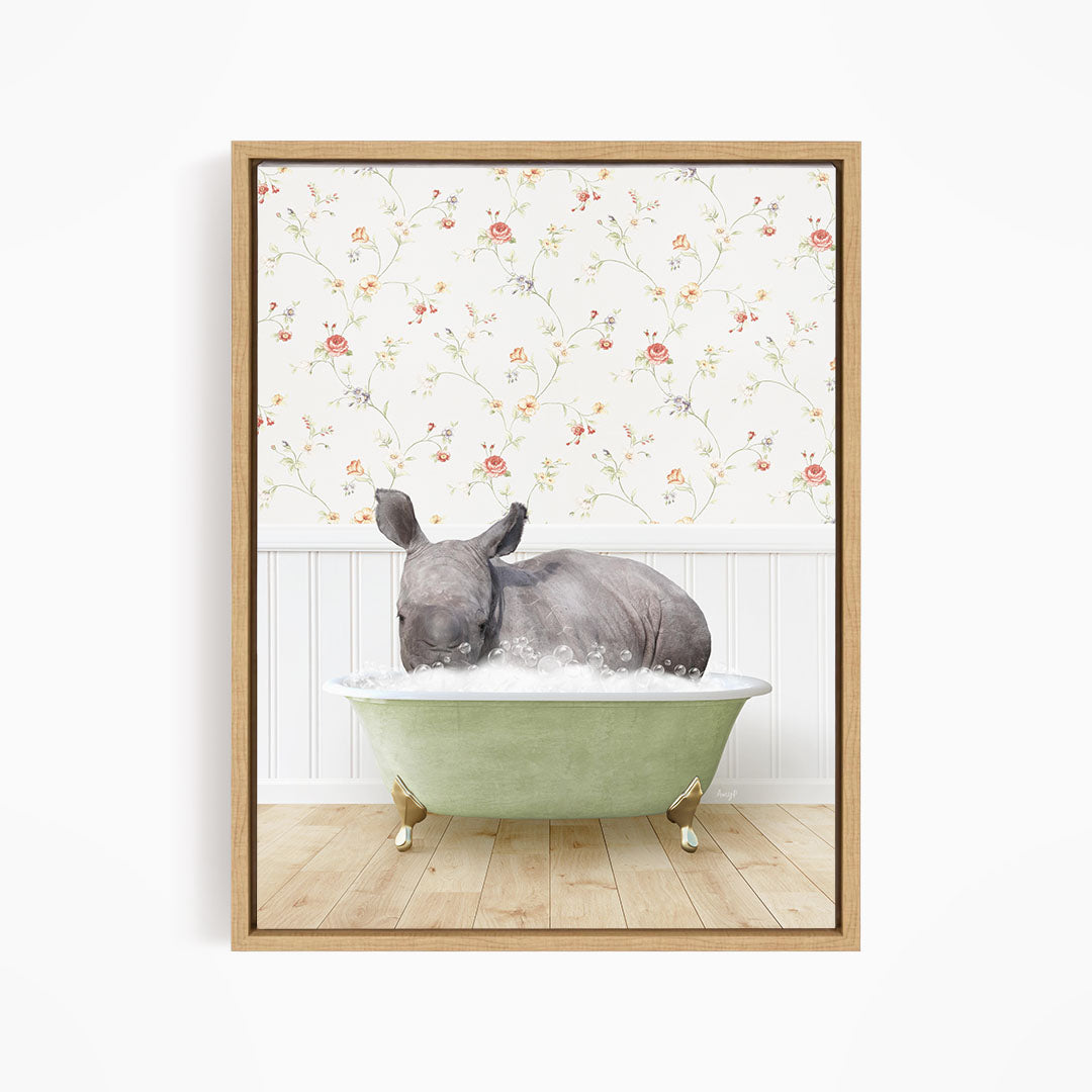 A rhinoceros is sitting in a green bathtub, surrounded by a floral wallpaper.