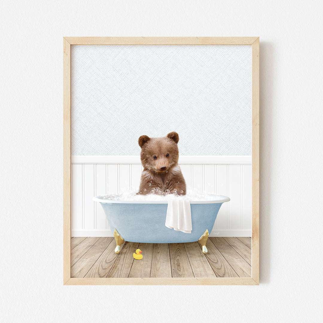 a brown teddy bear sitting in a blue bath tub