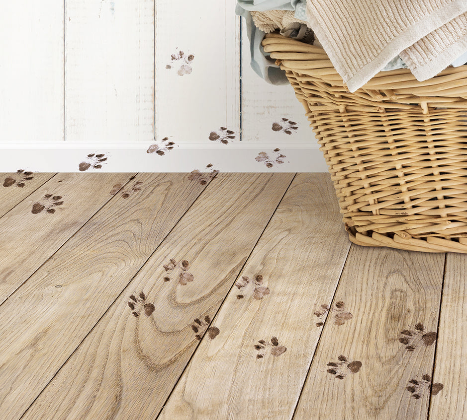 a basket with towels and paw prints on the floor