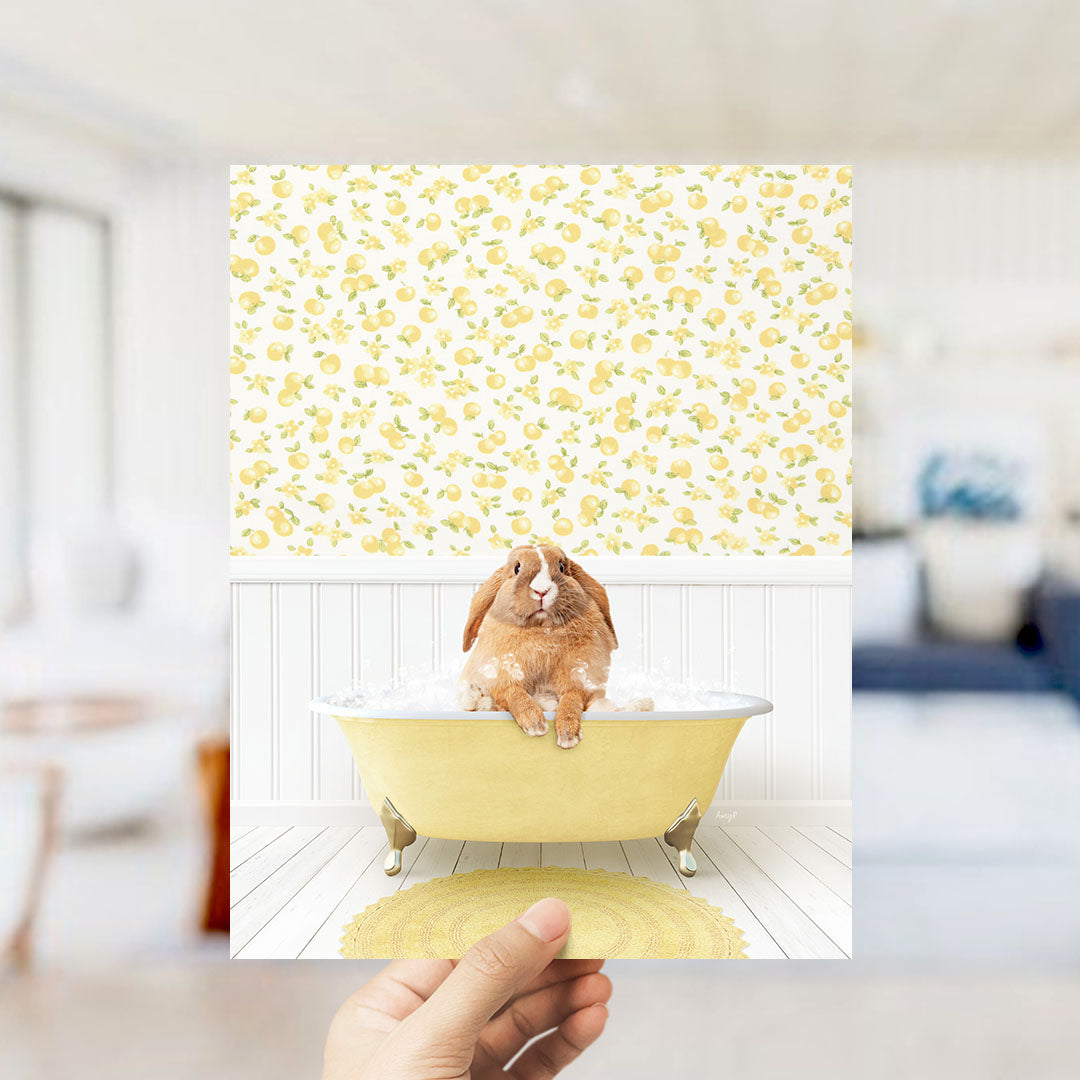 A brown rabbit sitting in a yellow bathtub filled with bubbles, surrounded by a yellow and white floral pattern on the wall.
