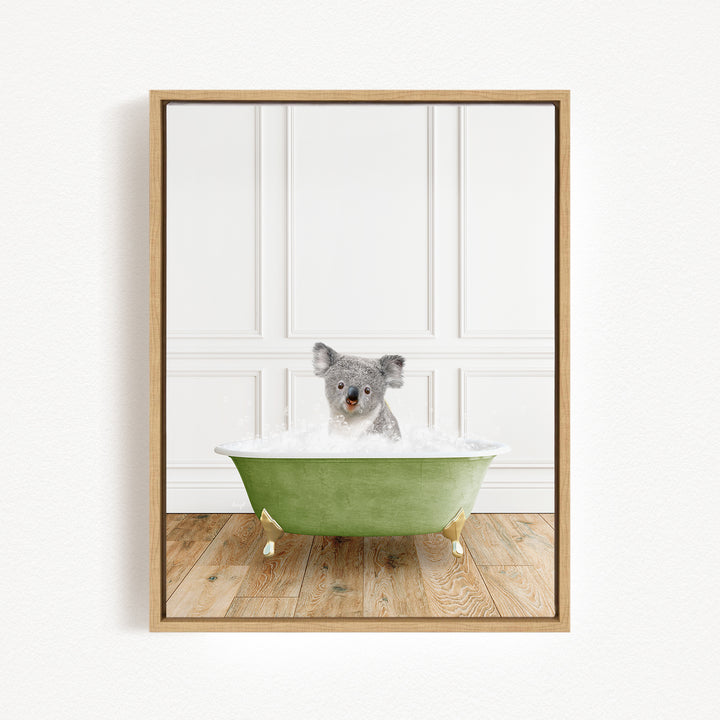 A koala bear sitting in a green bathtub filled with water, looking up at the camera.