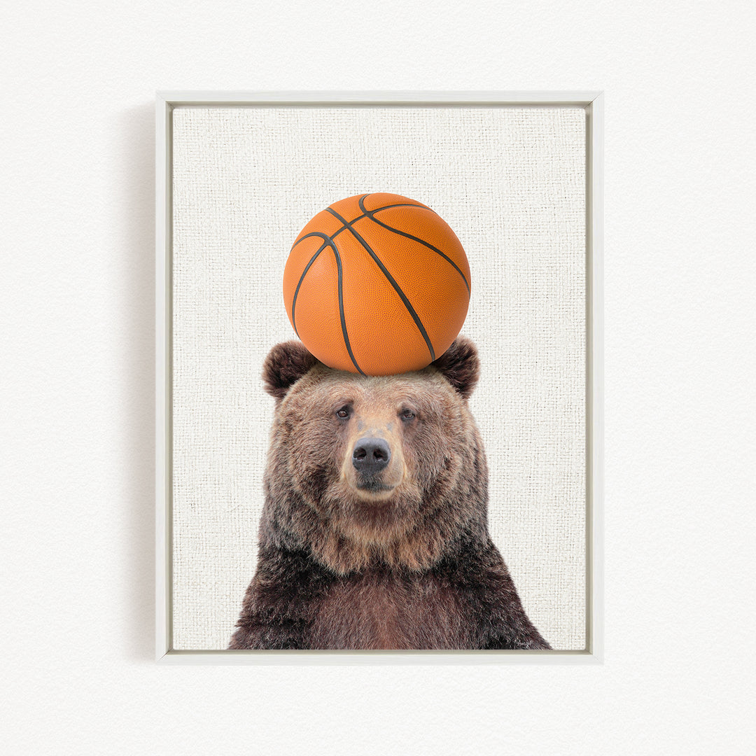 A brown bear balancing a basketball on its head.
