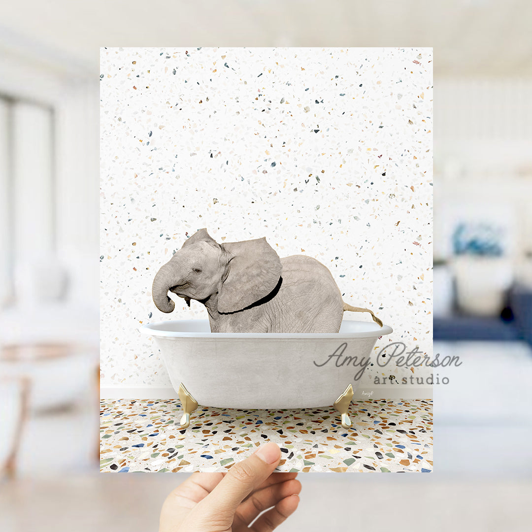 a hand holding up a card with an elephant in a bathtub