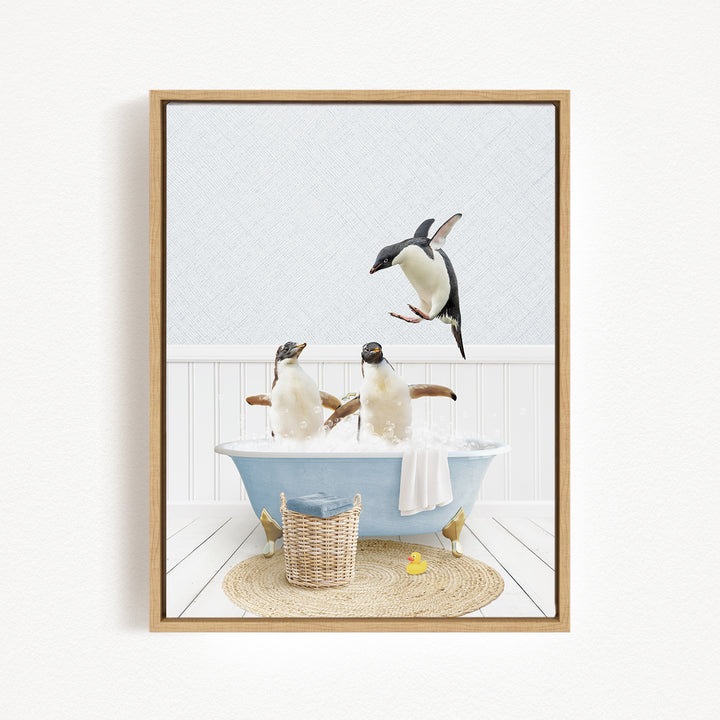 A framed image depicting two penguins sitting in a bathtub, with one penguin flying towards the other.