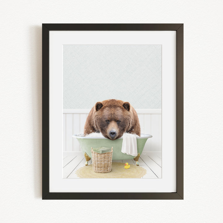 A brown bear is sitting in a green bathtub filled with water, surrounded by a basket of bath toys and a yellow rubber duck.