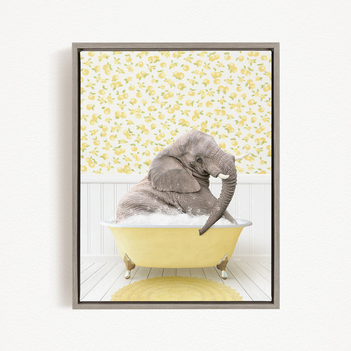 A gray elephant is sitting in a yellow bathtub filled with water, surrounded by a yellow floral pattern on the wall behind it.