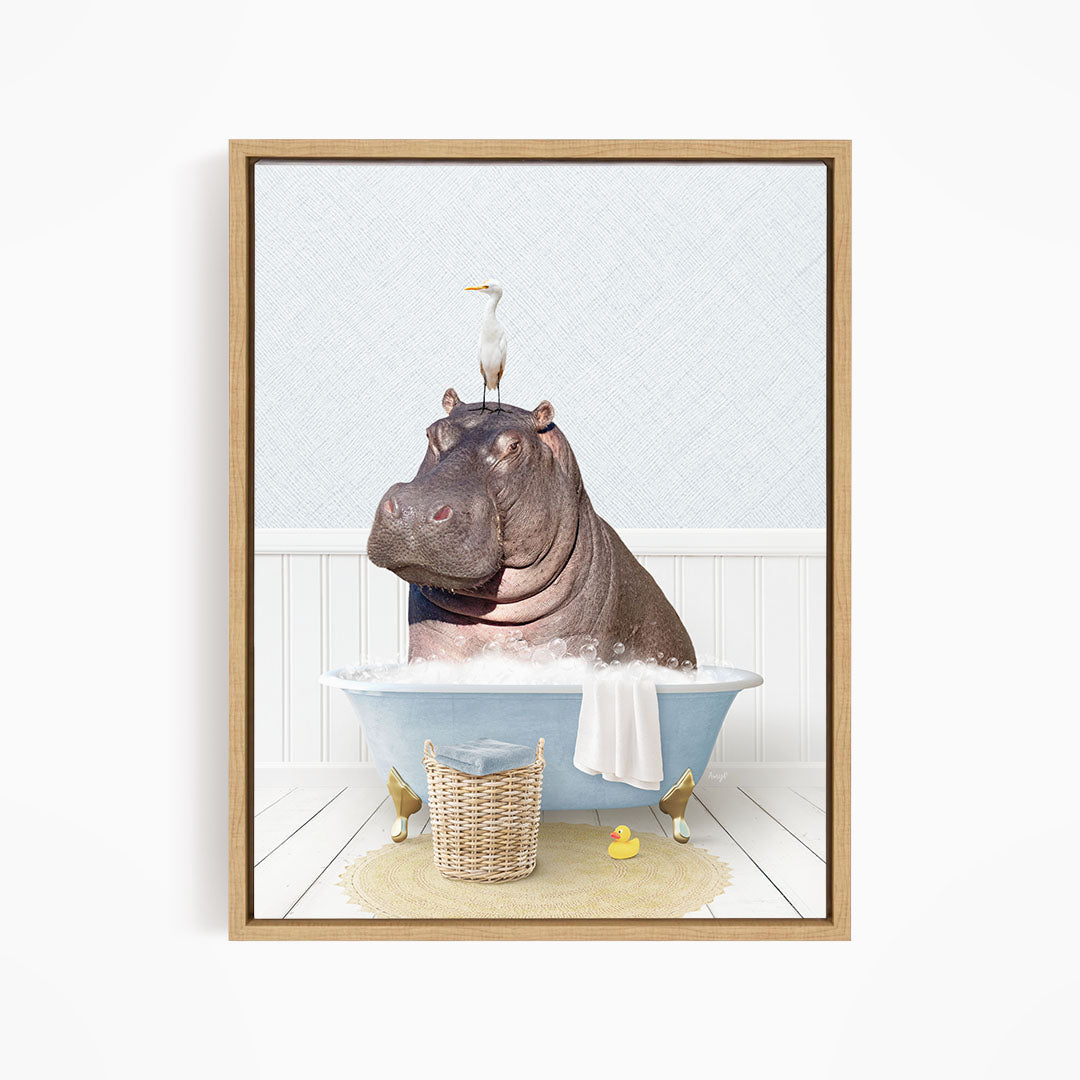 A framed image depicting a hippopotamus sitting in a bathtub, with a seagull perched on its head.