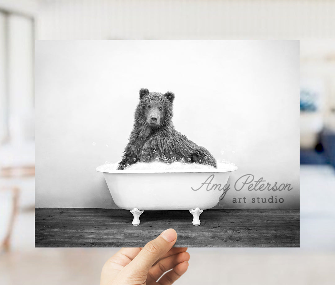 a black and white photo of a bear in a bathtub