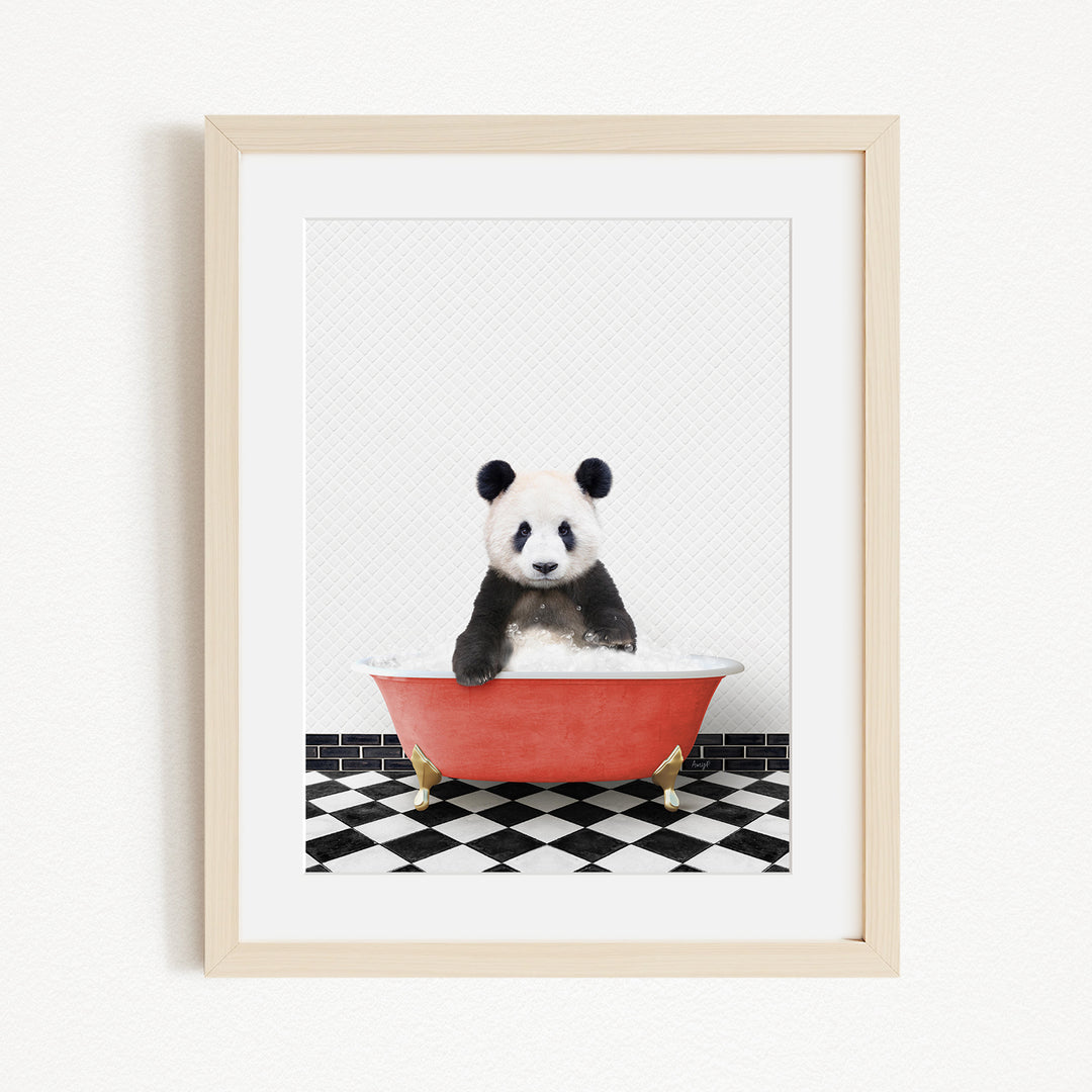 A panda bear sitting in a red bathtub on a black and white checkered floor.