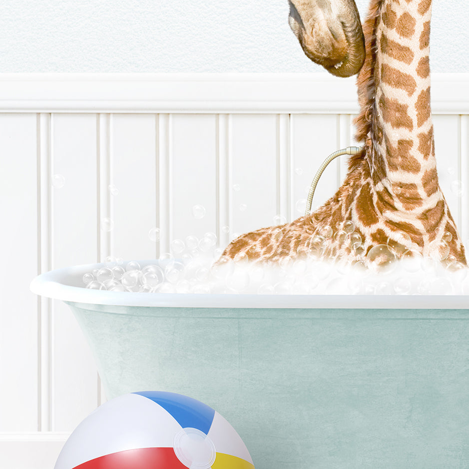 a baby giraffe in a bathtub with bubbles and a beach ball