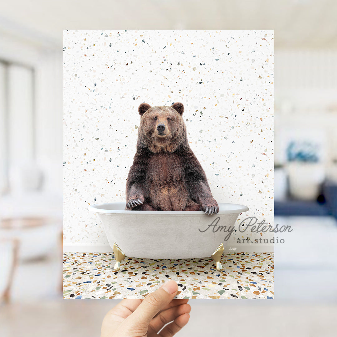 a hand holding up a card with a bear in a bathtub