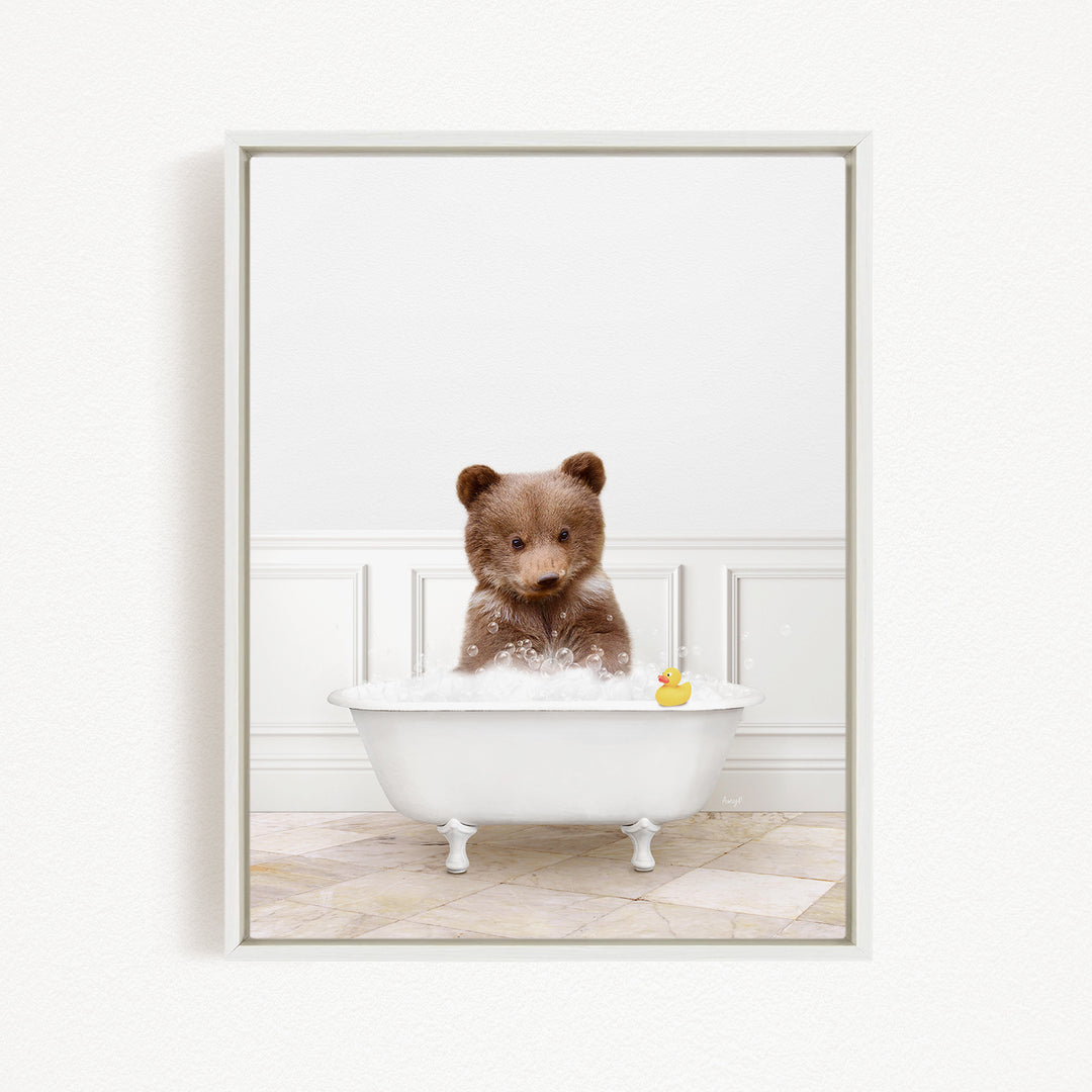 A brown bear sitting in a white bathtub, with a rubber duck floating in the water.