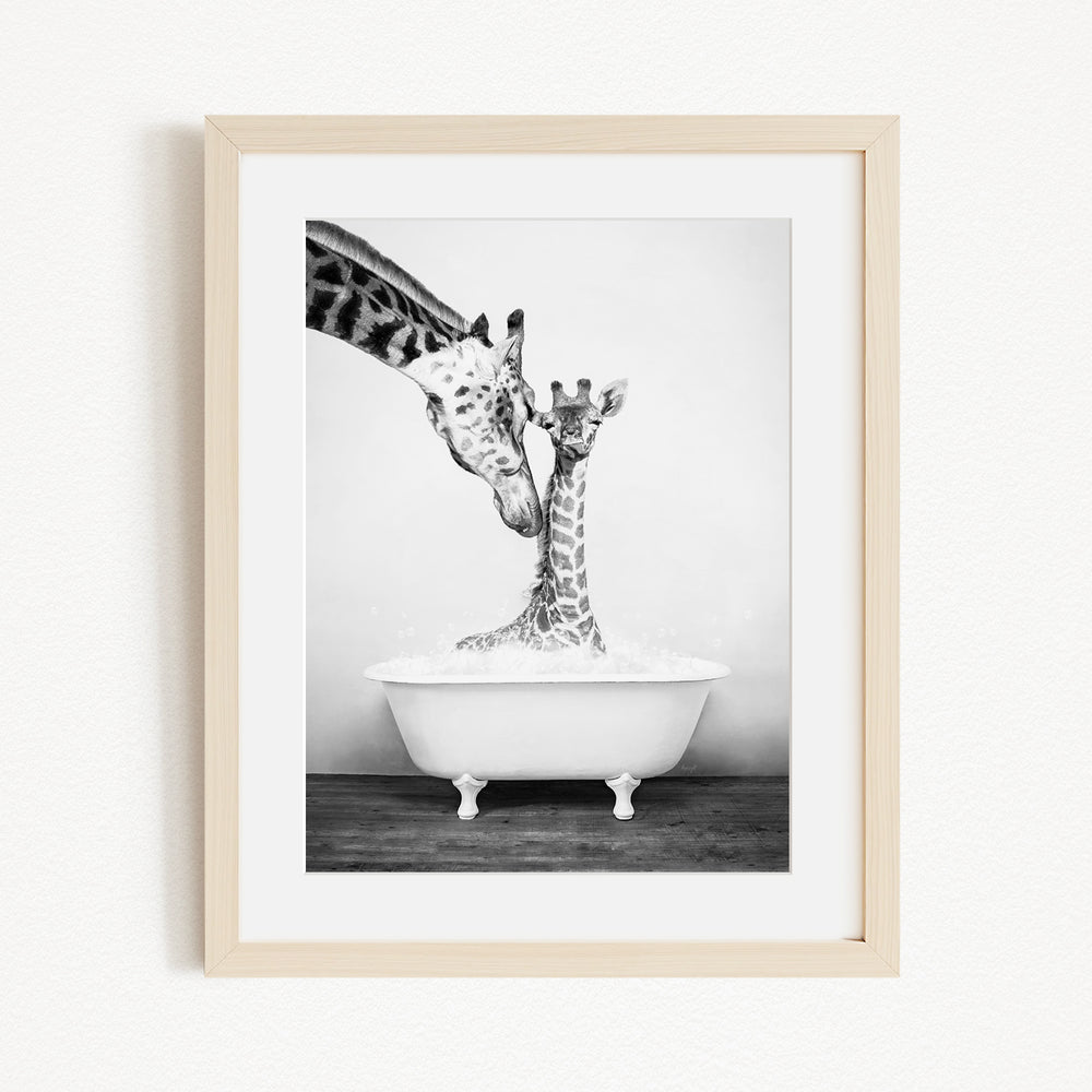 A mother giraffe and her baby giraffe enjoying a bath together in a white bathtub.