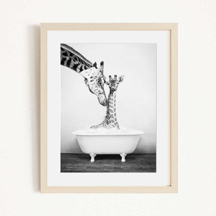 A mother giraffe and her baby giraffe enjoying a bath together in a white bathtub.