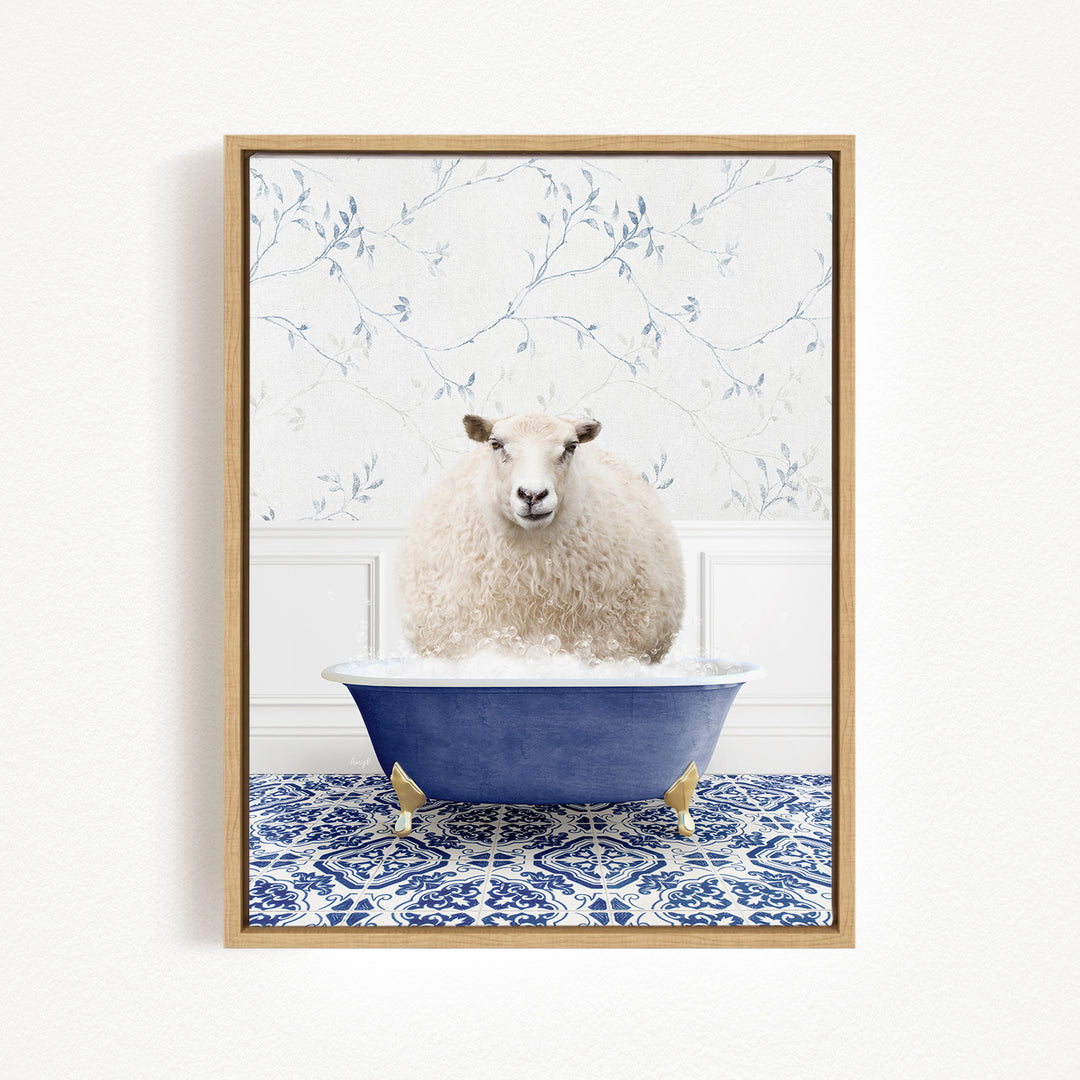 A fluffy white sheep sits in a blue bathtub, surrounded by a blue and white patterned tile floor.