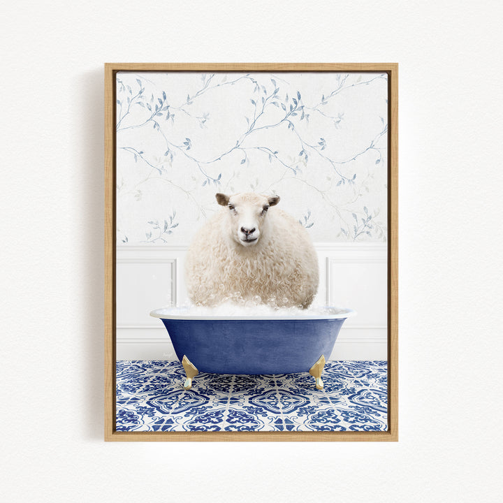 A fluffy white sheep sits in a blue bathtub, surrounded by a blue and white patterned tile floor.