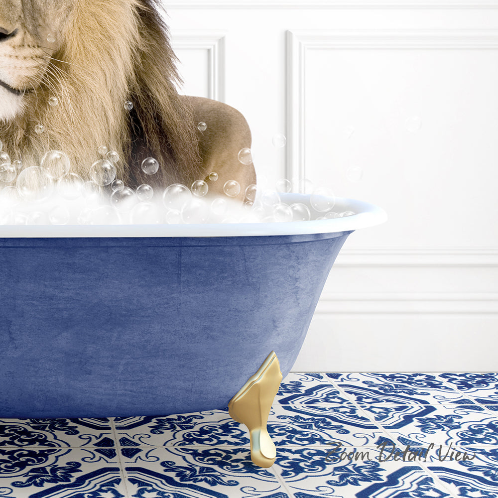 A lion is sitting in a blue bathtub filled with bubbles, with a gold-colored bathtub faucet and a patterned tile floor.