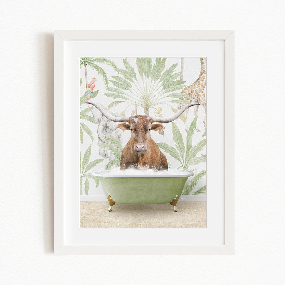 A framed image depicting a brown cow sitting in a green bathtub, surrounded by tropical foliage and a giraffe.