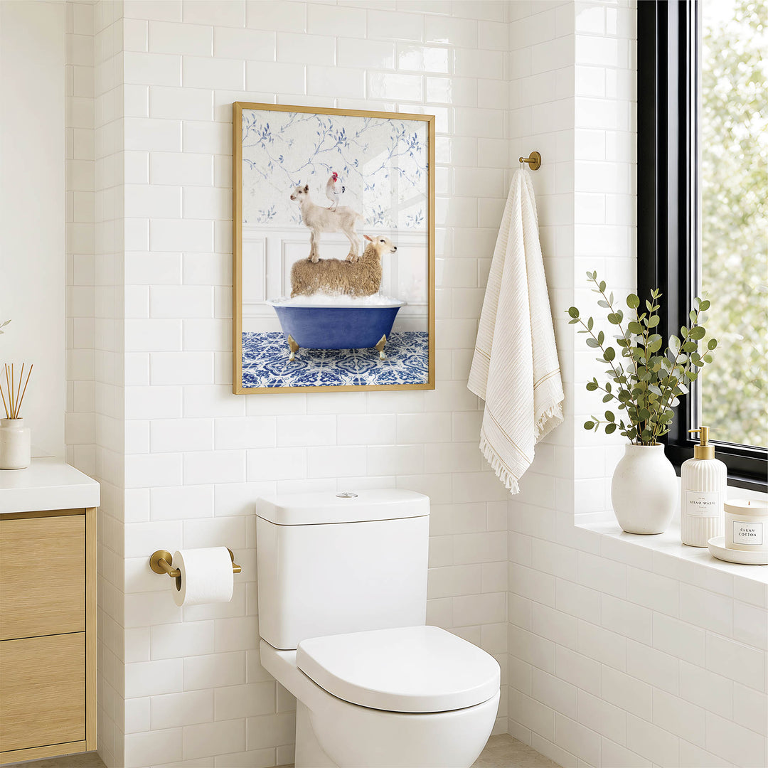 A bathroom with a white toilet, a framed picture of two dogs in a bathtub, and a window with greenery outside.