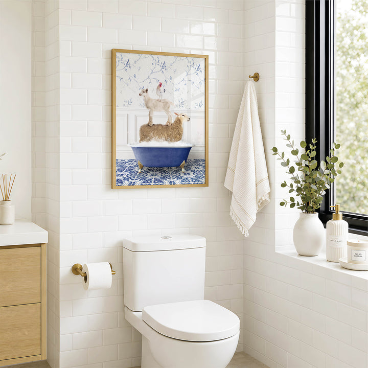 A bathroom with a white toilet, a framed picture of two dogs in a bathtub, and a window with greenery outside.