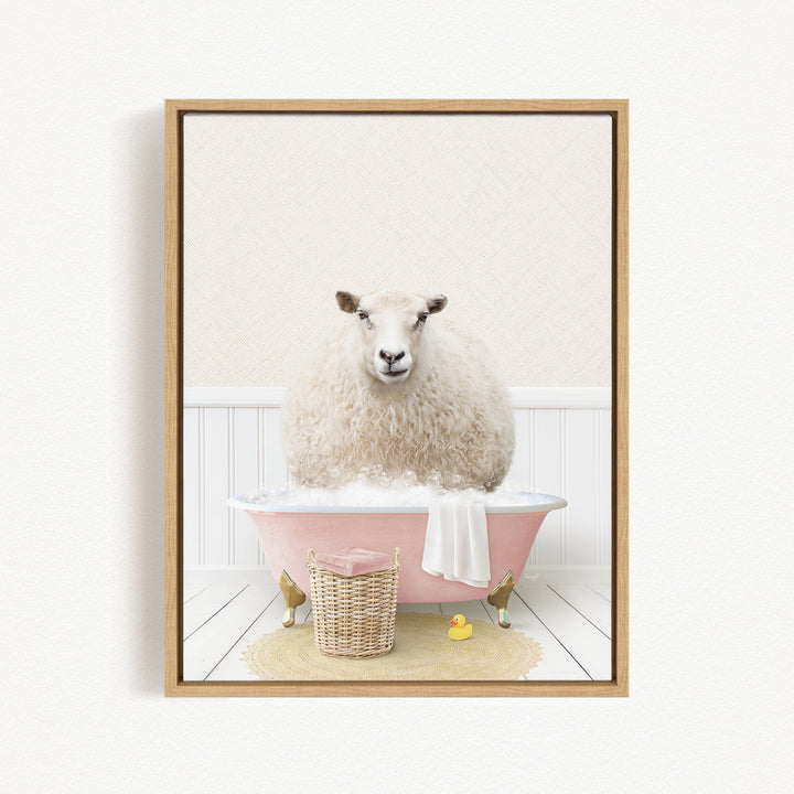 A fluffy white sheep sits in a pink bathtub filled with bubbles, surrounded by a basket of bath toys and a yellow rubber duck.