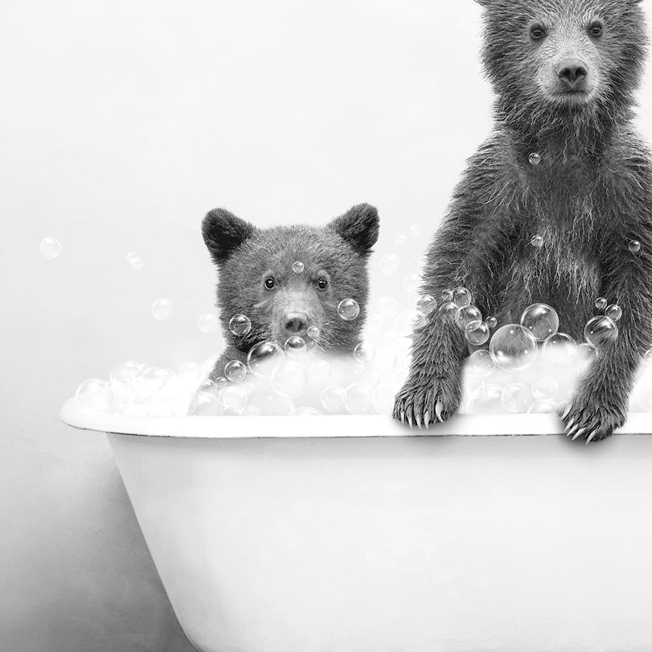 a black and white photo of two bears in a bathtub