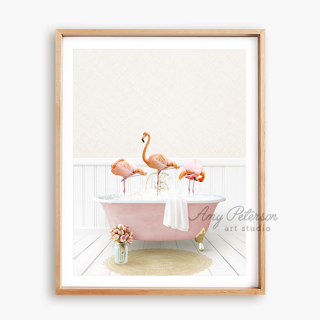 a pink bathtub with three flamingos in it