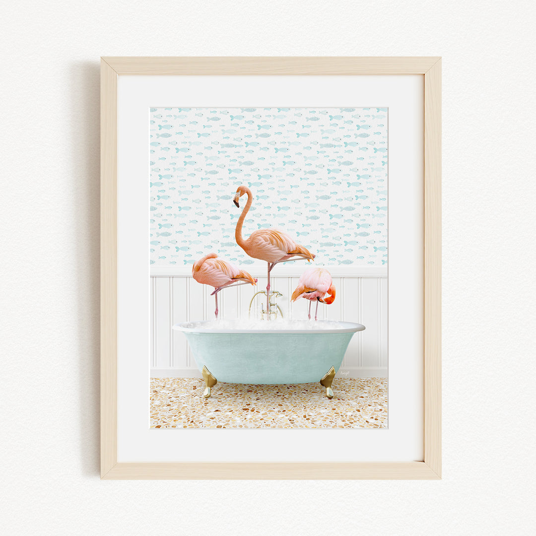 A framed image depicting three flamingos standing in a bathtub filled with water, with a patterned wall behind them.