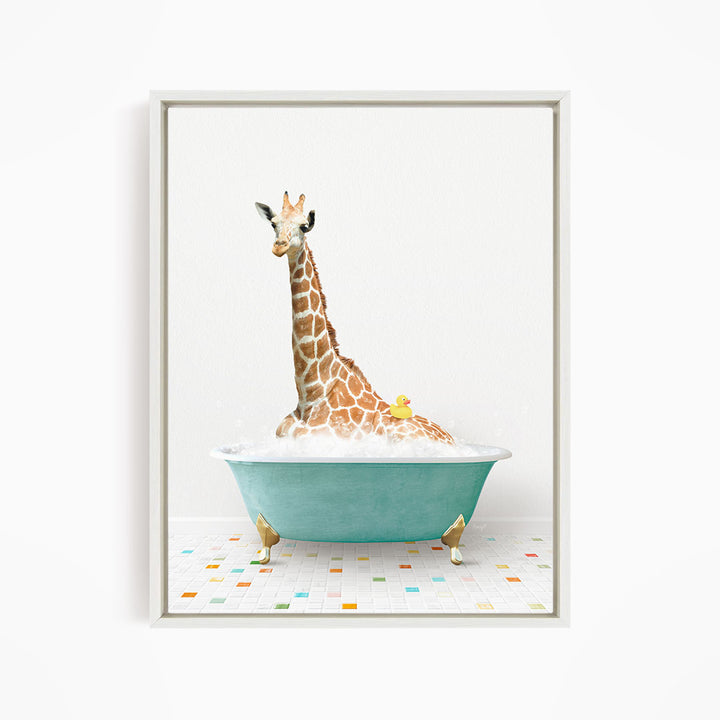 A giraffe is sitting in a blue bathtub filled with bubbles, with a yellow rubber duck floating on the water.