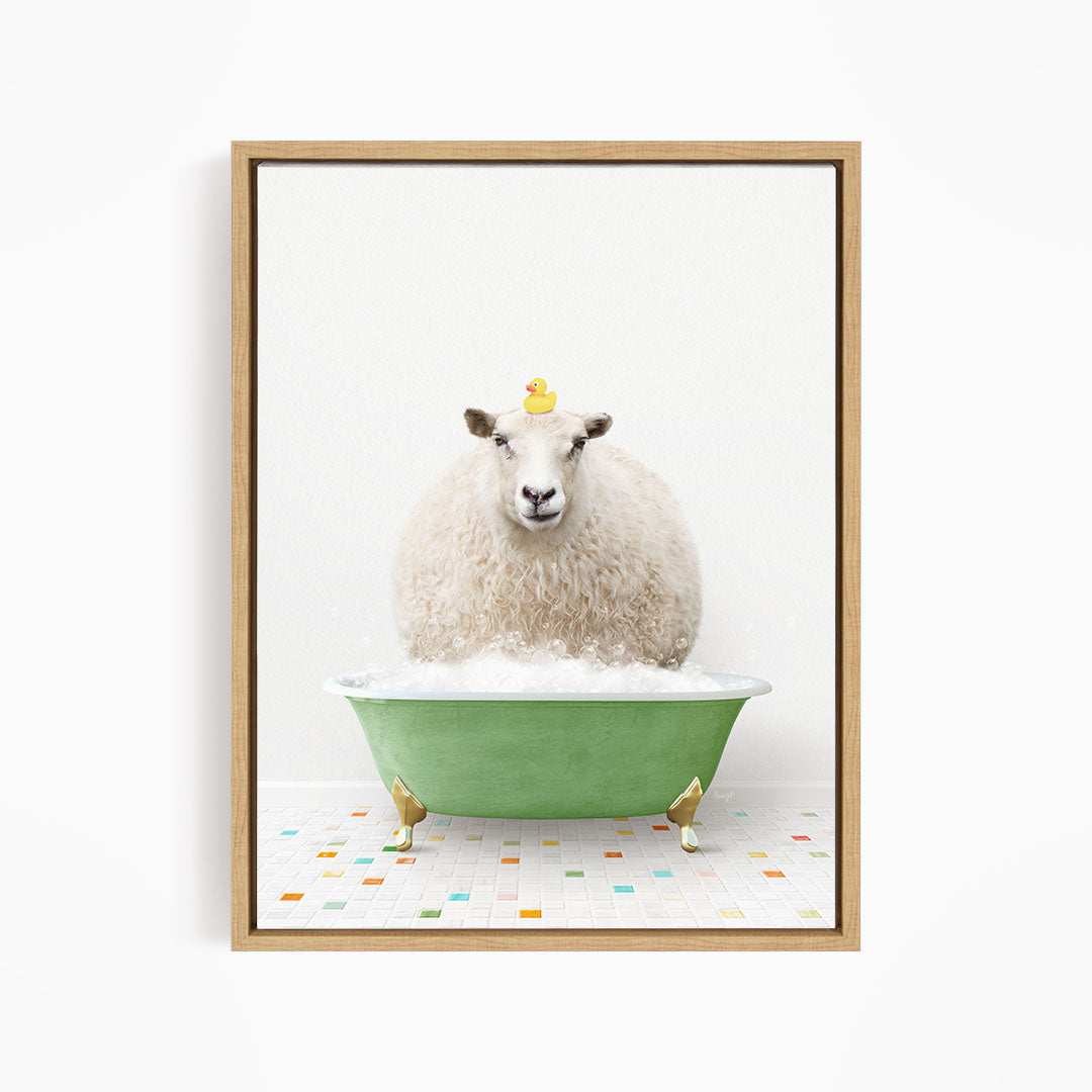 A fluffy white sheep sits in a green bathtub filled with bubbles, with a yellow rubber duck perched on its head.
