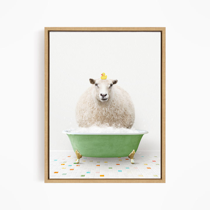 A fluffy white sheep sits in a green bathtub filled with bubbles, with a yellow rubber duck perched on its head.