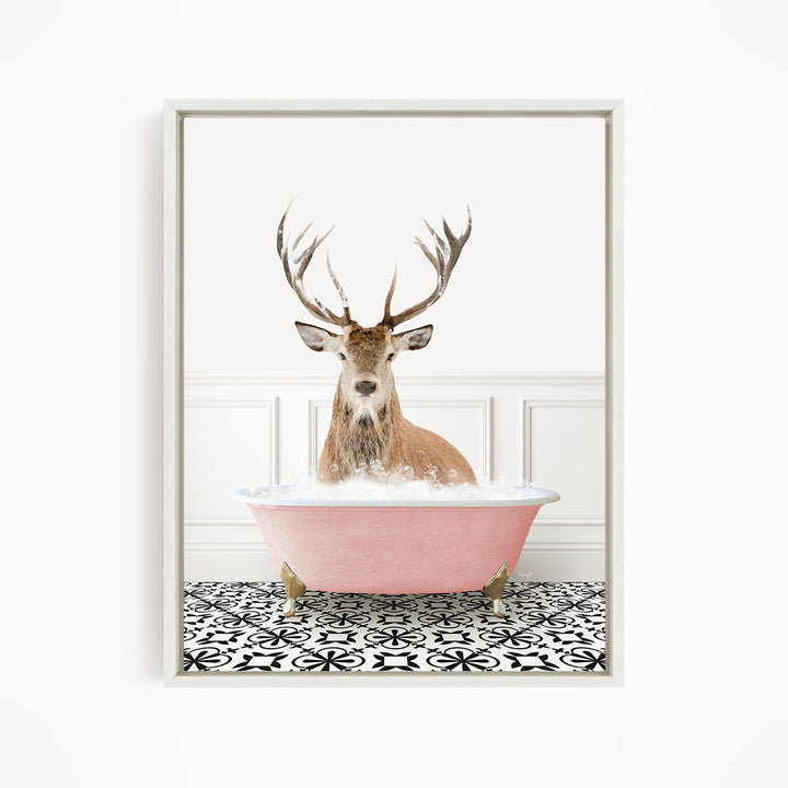 A deer with large antlers is sitting in a pink bathtub filled with bubbles, creating a whimsical and unexpected scene.