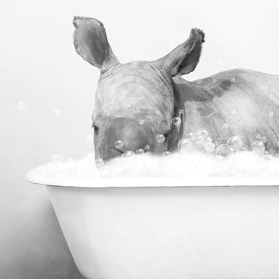 a black and white photo of a rhino in a bathtub