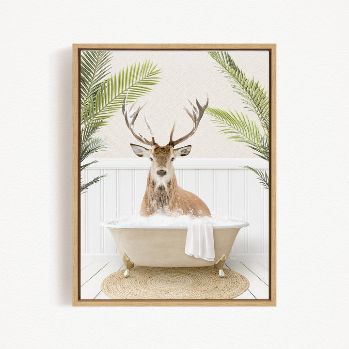 A deer with antlers is sitting in a bathtub filled with water, surrounded by green plants.